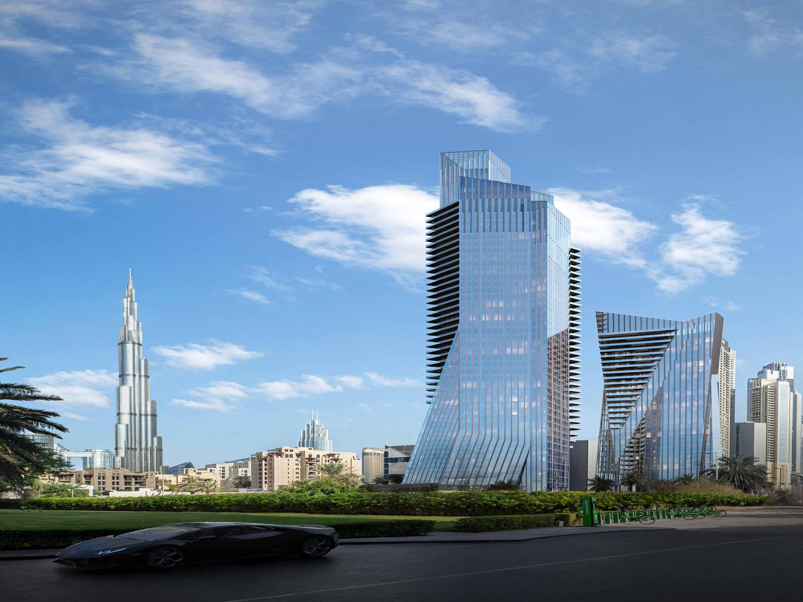 a car driving down a street next to tall buildings